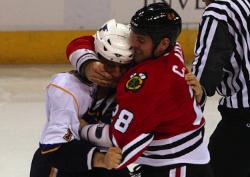 Blues Dan Hinote and Hawks Craig Adams drop the gloves :02 into the game (Bill Greenblatt, UPI)