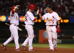 Cesar Izturis congratulated by teammates after his check swing winner (Bill Greenblatt,UPI)