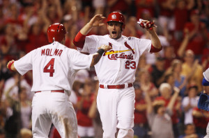 St. Louis Cardinals David Freese and Yadier Molina celebrate at home plate after scoring on a single by Daniel Descalso in the eighth inning against the Kansas City Royals at Busch Stadium in St. Louis on May 29, 2013. St. Louis won the game 5-3. UPI/Bill Greenblatt