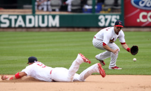 St. Louis Cardinals Matt Carpenter fields a ball that first baseman Matt Adams dived for off the bat of San Diego Padres Will Venable in the ninth inning at Busch Stadium in St. Louis on July 21, 2013.  Carpenter threw to pitcher Edward Mujica who covered the bag for the out. St. Louis won the game 3-2.     UPI/Bill Greenblatt