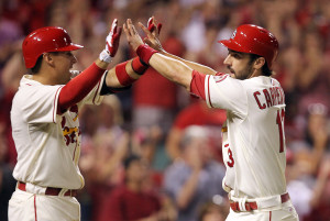 St. Louis Cardinals Matt Carpenter (R) slaps hands with Allen Craig after crossing home plate on a two RBI double by Matt Holliday in the seventh inning against the Atlanta Braves at Busch Stadium in St. Louis on August 24, 2013. UPI/Bill Greenblatt