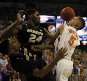 Torren Jones (34) and Tony Criswell of Missouri, battle Florida's Scottie Wilbekin for a loose ball. (photo/Mizzou athletics)