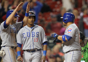 Chicago Cubs Wellington Castillo (R) is welcomed at home plate by Nate Schierholtz and Starlin Castro after hitting a three run home run in the 11th inning against the St. Louis Cardinals at Busch Stadium in St. Louis on April 11 2014. Chicago won the game 6-3. UPI/Bill Greenblatt