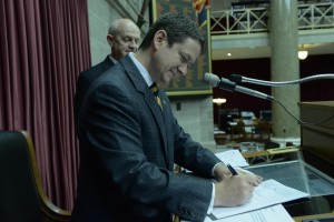 House Speaker Tim Jones signs SB 509, the proposed $620-million a year tax cut proposal.  (photo courtesy; Tim Bommel, Missouri House Communications)