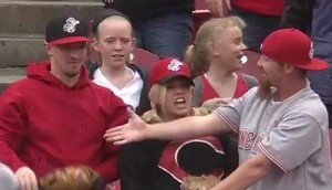 Cincinnati fans react after Matt Adams has a foul ball encounter with the fan on the left.  