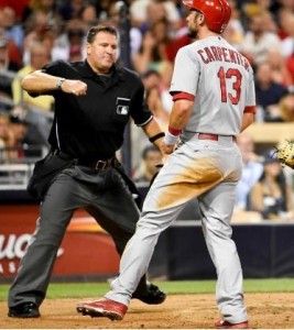 Home plate umpire Tony Randazzo calls Matt Carpenter out at home in the fifth inning. (photo/MLB)