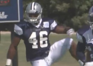 Michael Sam stretches during his first workout with the Cowboys.