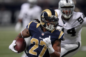 St. Louis Rams Tre Mason runs the football past the Oakland Raiders defense for a 35-yard touchdown in the first quarter against the Oakland Raiders at the Edward Jones Dome in St. Louis on November 30, 2014. St. Louis won the game 52-0. UPI/Bill Greenblatt