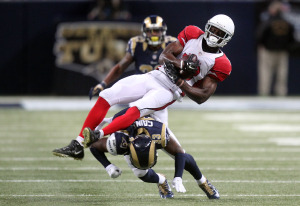 St. Louis Rams E.J. Gaines upends Arizona Cardinals Jaron Brown in the first quarter at the Edward Jones in St. Louis on December 11, 2014.    UPI/Bill Greenblatt