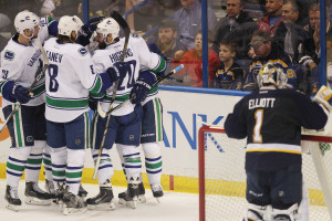 St. Louis Blues goaltender Brian Elliott collects his thoughts as Vancouver Canucks players celebrate a Radim Vrbata goal in the third period at the Scottrade Center in St. Louis on March 30, 2015. Vancouver won the game 4-1. Photo by Bill Greenblatt/UPI