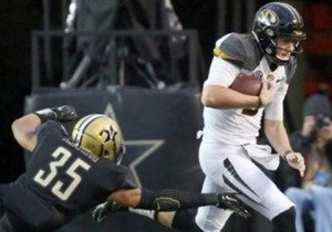 Drew Lock avoids the tackle of a Vandy player (photo/Mizzou Athletics)