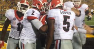 Georgia players mob Isaiah McKenzie after he scores the go-ahead touchdown (photo/Bill Pollock, Missourinet)