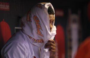 St. Louis Cardinals pitcher Alex Reyes watches the third inning against the Chicago Cubs from underneath a towel in the dugout at Busch STadium in St. Louis on September 13, 2016 Photo by Bill Greenblatt/UPI