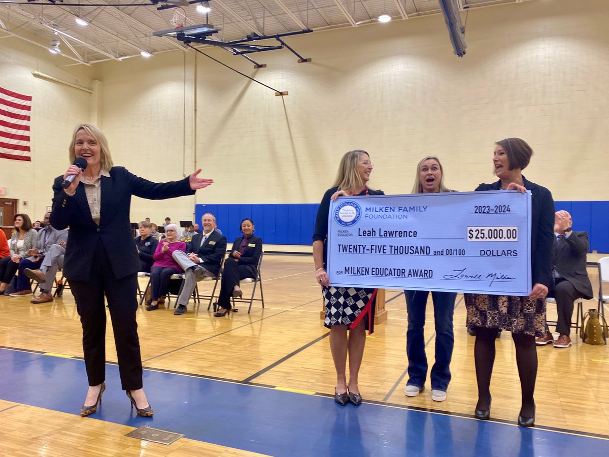 Education Commissioner Margie Vandeven helps to present the Milken Educator Award to Leah Lawrence, a teacher at St. Charles School District